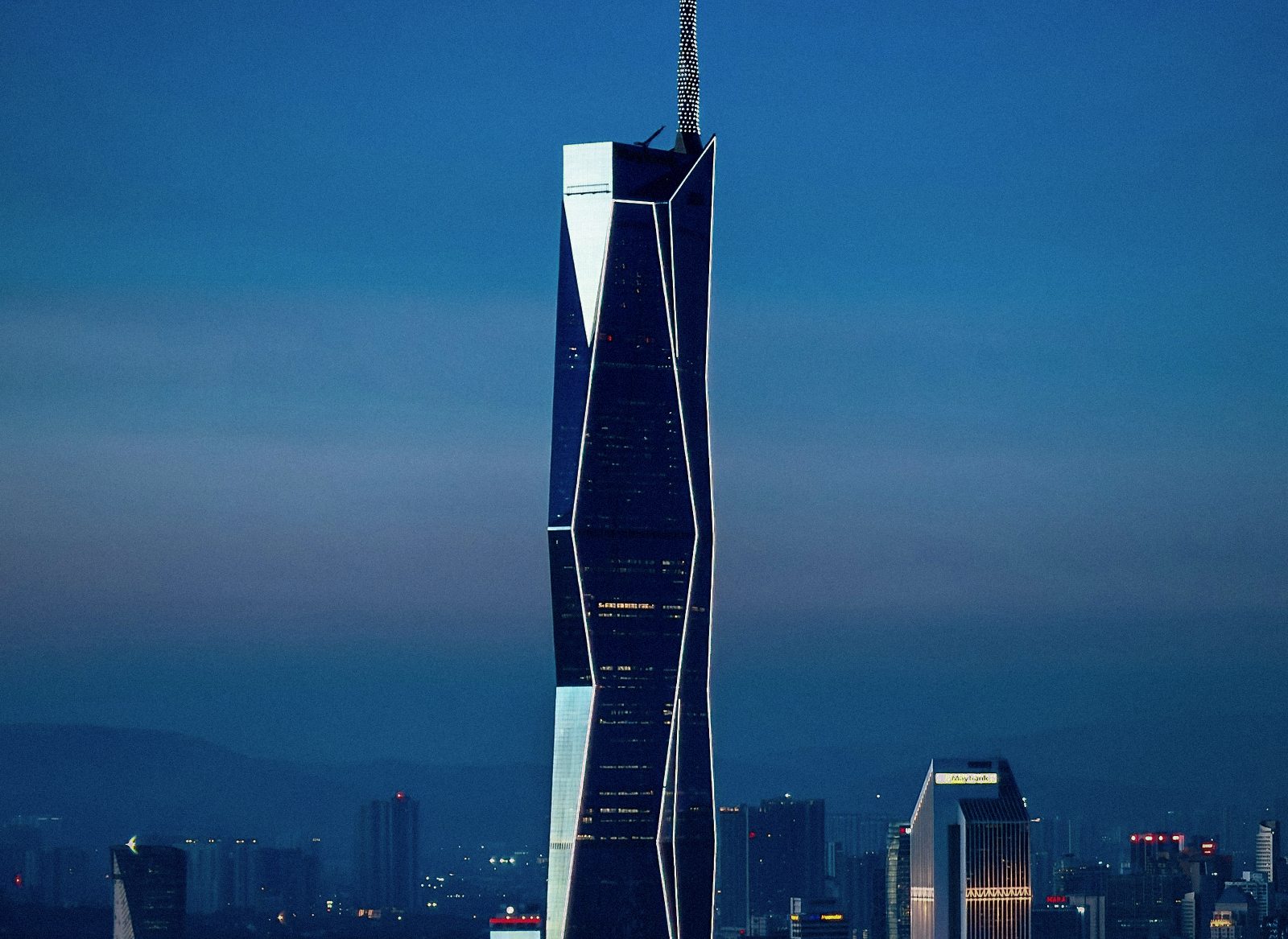 Merdeka 118 rising over the Kuala Lumpur skyline at dusk